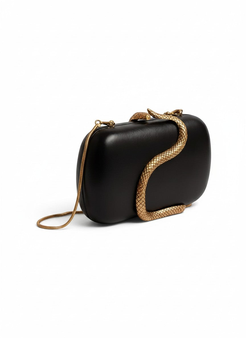 THE GOOD FIND black clutch with gold-tone snake embellishment and chain strap.