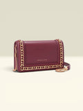 THE GOOD FIND burgundy faux leather shoulder bag with gold-tone chain embellishments and adjustable strap.