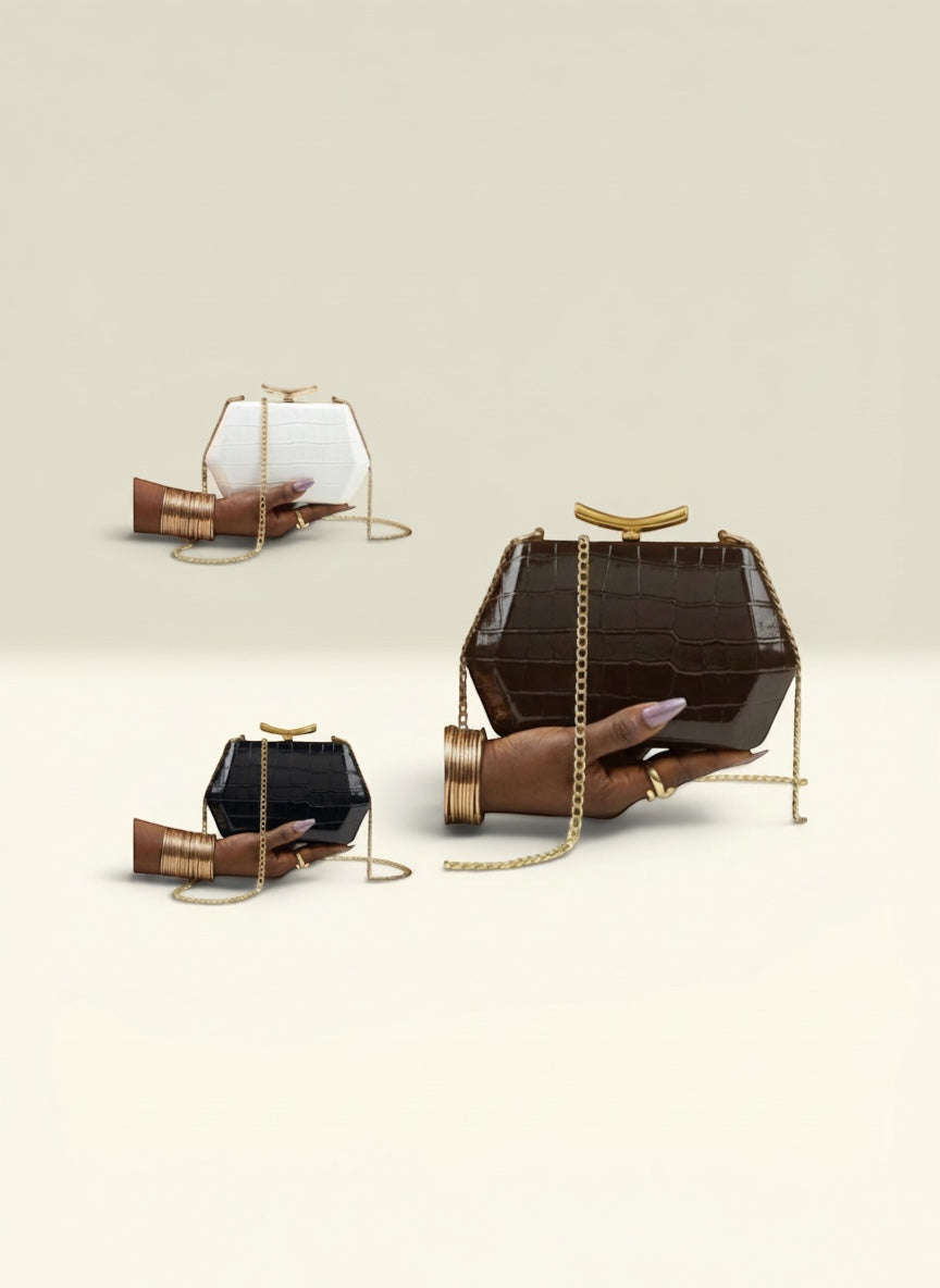 THE GOOD FIND geometric clutch in faux croc leather, available in black, white, and chocolate brown. Features gold-tone chain strap.