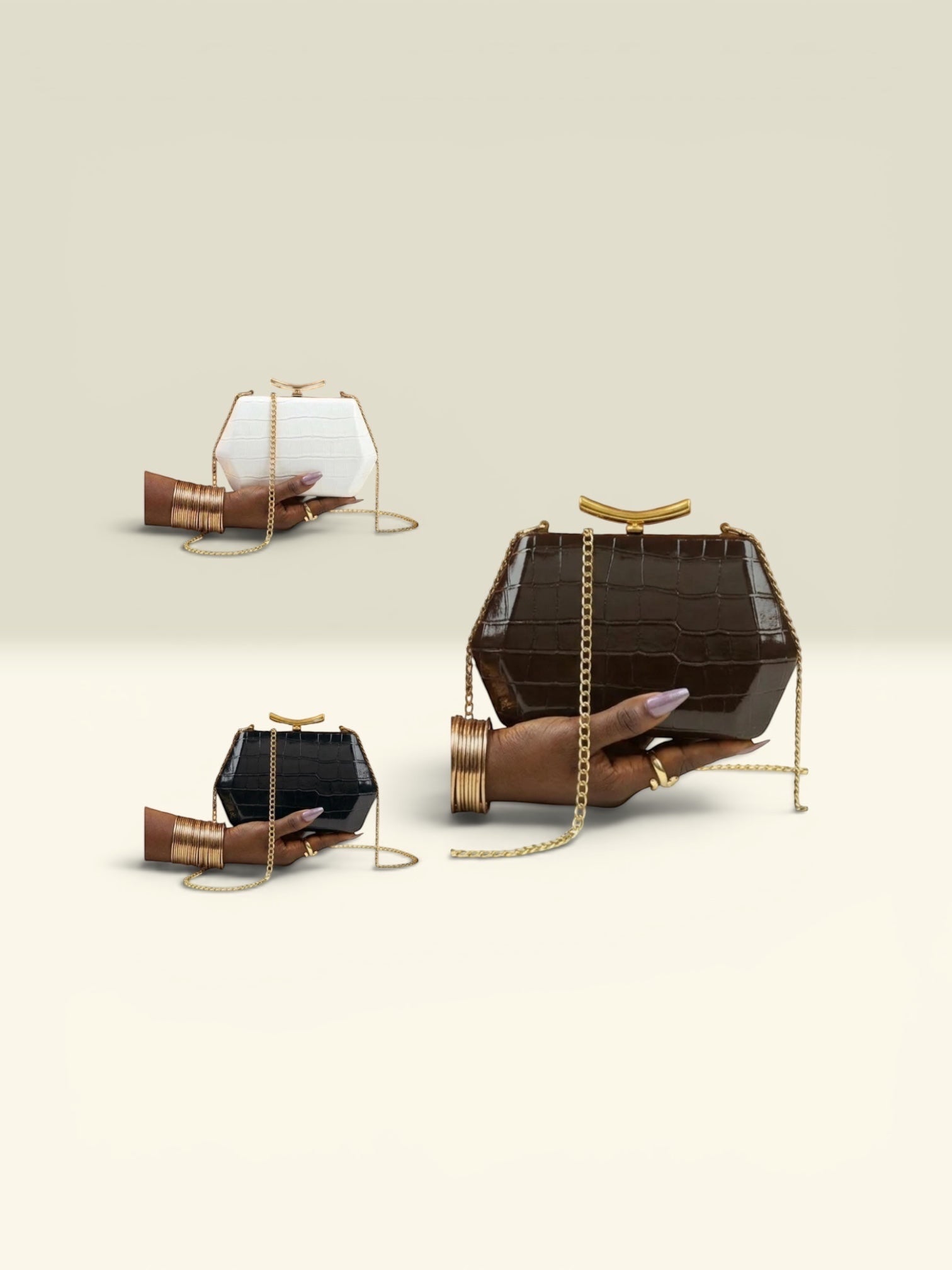 THE GOOD FIND geometric clutch in black, white, and chocolate brown faux croc leather with gold chain.