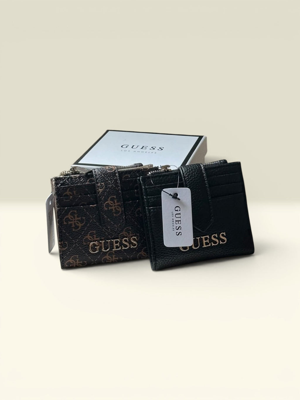 THE GOOD FIND Guess card holder and wallet set in brown logo print and black faux leather with gold hardware.