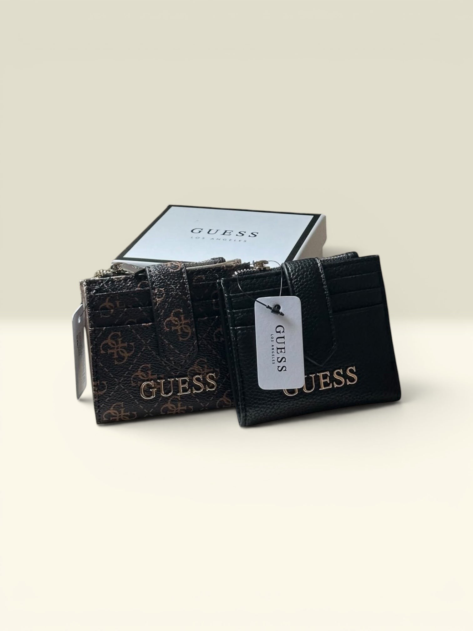 THE GOOD FIND Guess card holder and wallet set in brown logo print and black faux leather with gold hardware.