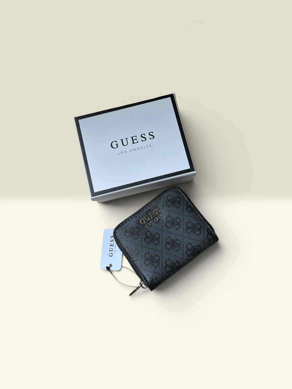 THE GOOD FIND Guess black faux leather zip-around wallet with all-over logo print and gold hardware.