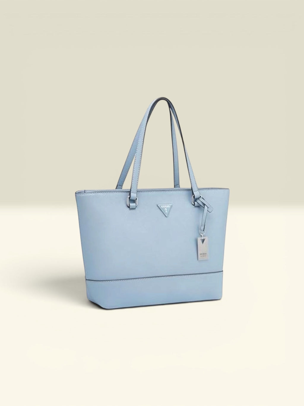 THE GOOD FIND light blue faux leather tote bag with top handles and a silver logo charm.