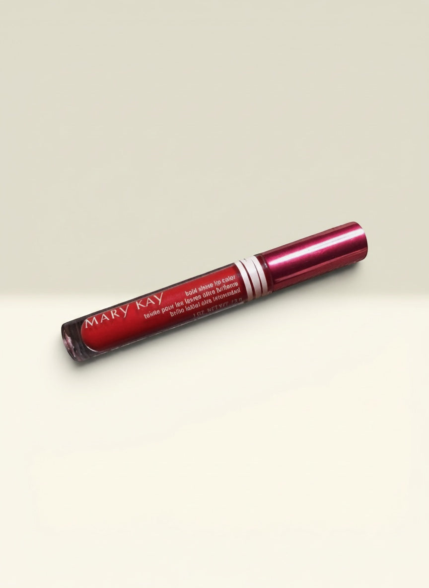 THE GOOD FIND Mary Kay Bold Shine Lip Color in vibrant red with a high-shine finish. The metallic red cap has white stripes.