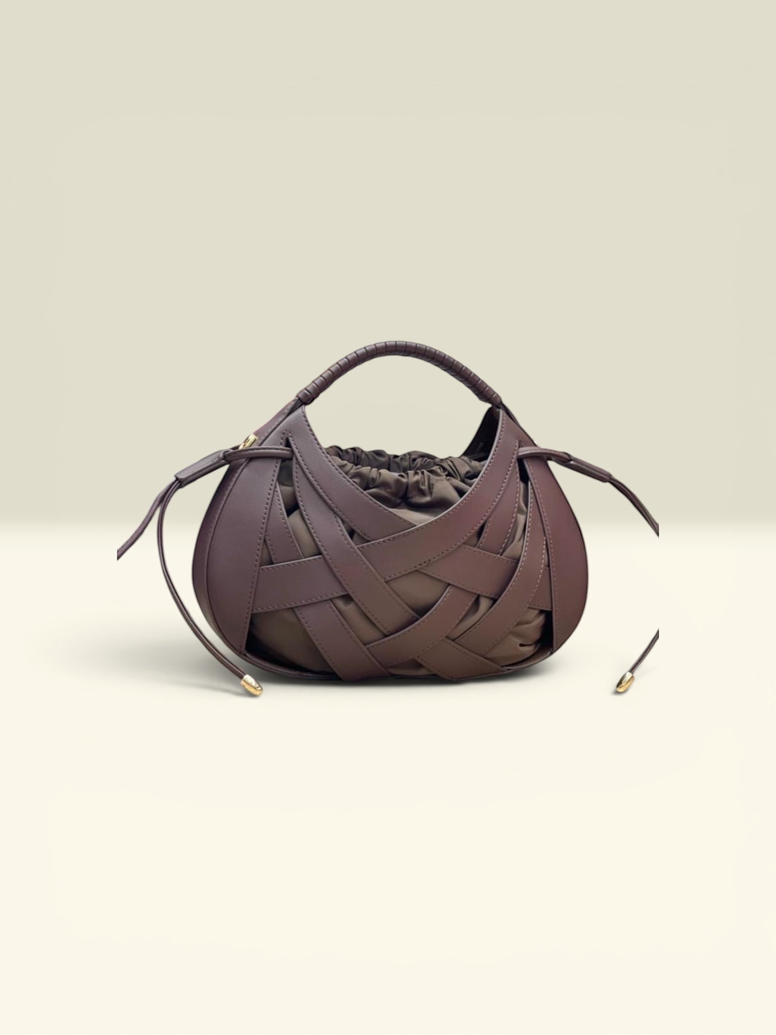 THE GOOD FIND woven leather drawstring handbag in deep brown with gathered interior and top handle.